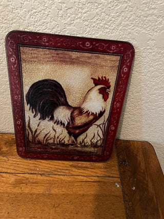 Glass cutting board with a rooster design, likely part of a farmhouse     RCD