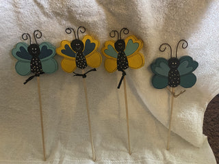 Wooden butterfly on a gardening stake