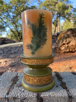JP Pier One decorative botanical pillar candle featuring embedded olive-green pedestal holder