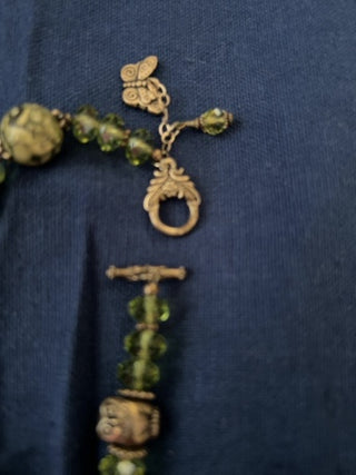 Green beaded bracelet with metal butterfly