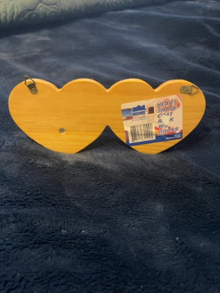 vintage wooden wall-mounted peg rack featuring two heart-shaped cutouts