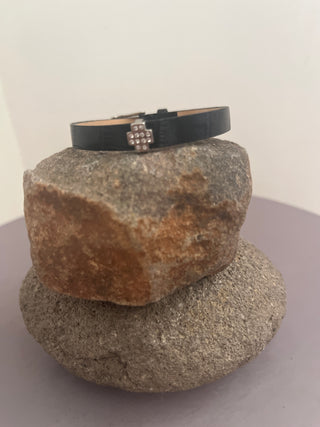Black bracelet with silver cross