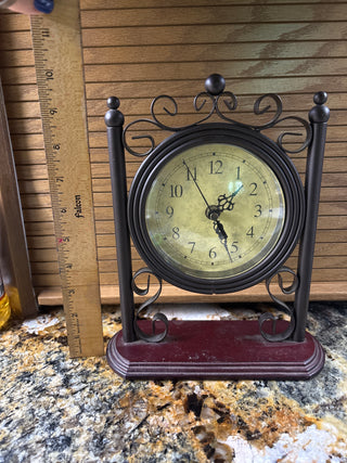 Antique style tabletop clock with metal scroll work