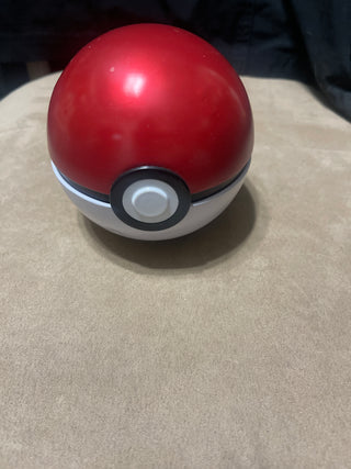 Pokémon ball and trading cards and two coins