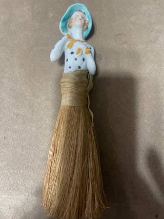 large whisk  broom, woman with polkadotted dress