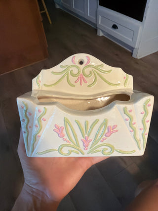 white wall pocket with pink and green detail