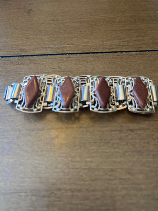 Bracelet gold.  Brown diamond shapes.