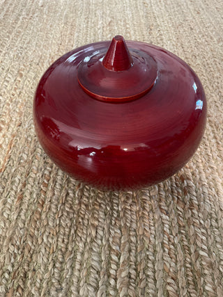 Large red decorative bowl with lid